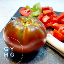 Load image into Gallery viewer, Cherokee Purple Heirloom Tomato sliced on Cutting Board
